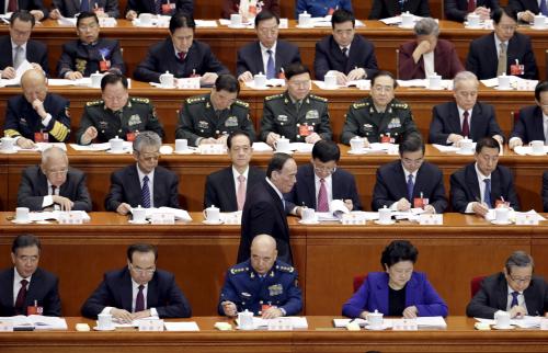 China's Politburo Standing Committee member Wang Qishan (bottom row, C), the head of China's anti-corruption watchdog, walks toward his seat during the opening session of the National People's Congress (NPC) in Beijing, China, March 5, 2016. REUTERS/Jason Lee TPX IMAGES OF THE DAY