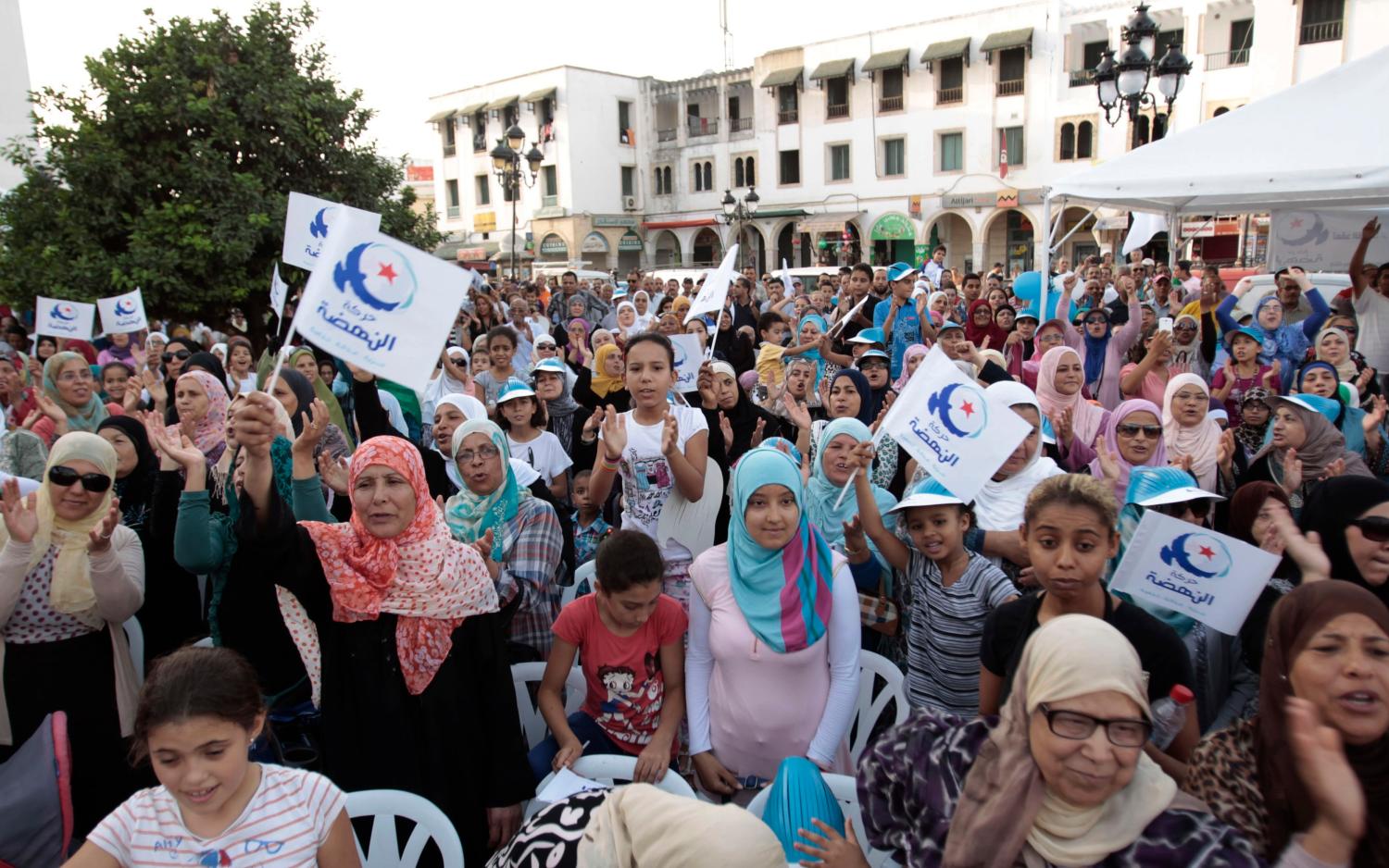 Supporters of the Islamist Ennahda movement wave national and party flags during a campaign event in Tunis October 12, 2014. Tunisia will hold parliamentary elections on October 26 and a presidential ballot in November. REUTERS/Zoubeir Souissi (TUNISIA - Tags: POLITICS ELECTIONS) - RTR49W9N