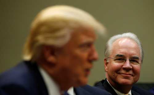 Health and Human Services Secretary Tom Price (R) listens to U.S. President Donald Trump speak.