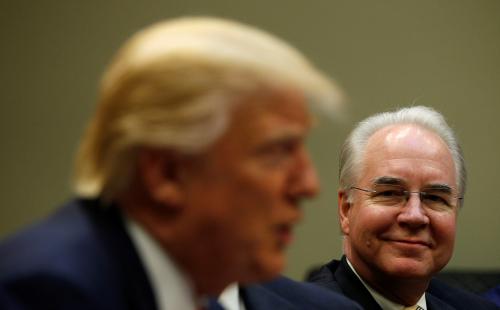 Health and Human Services Secretary Tom Price (R) listens to U.S. President Donald Trump speak.