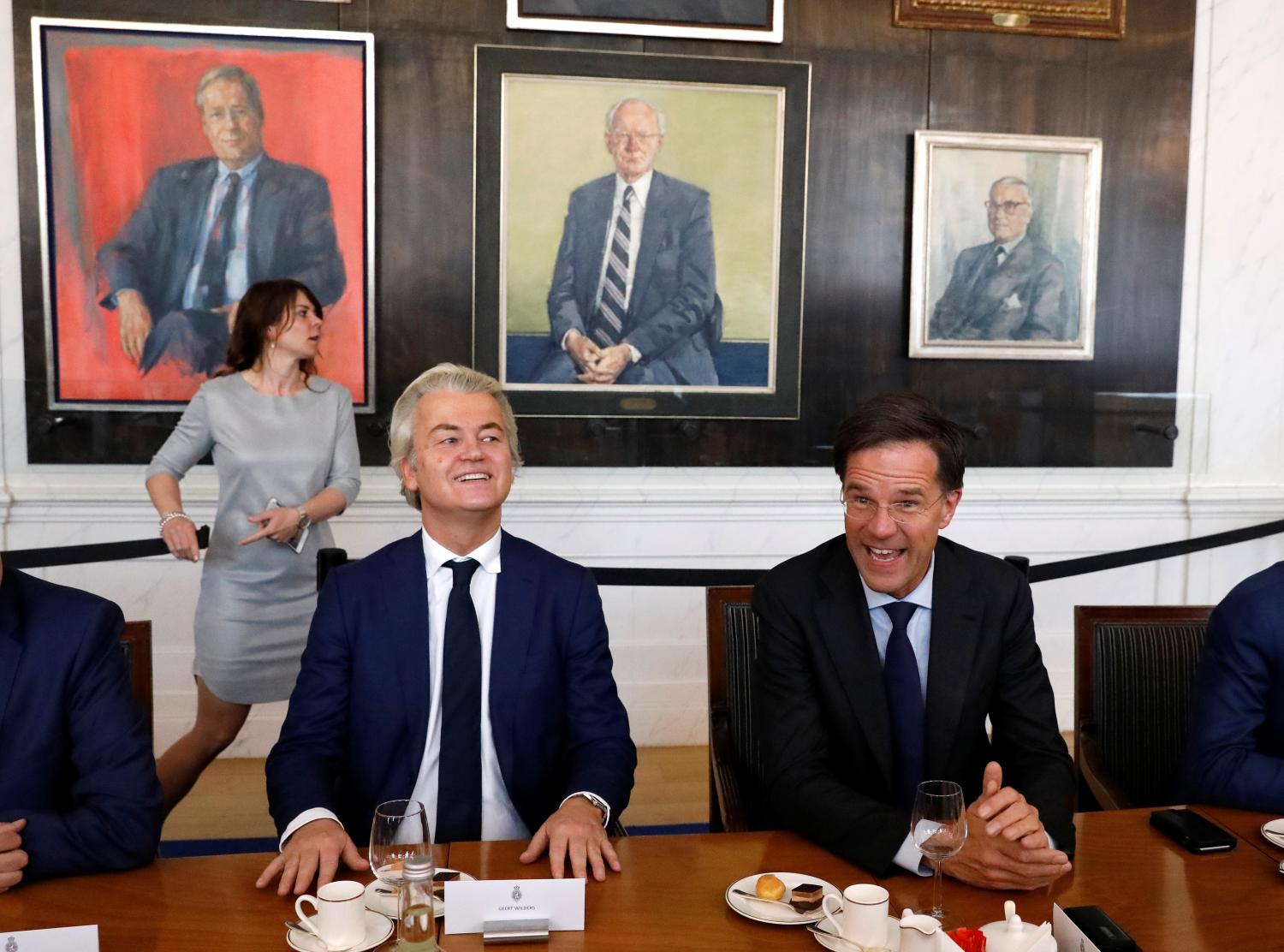 Dutch Prime Minister Mark Rutte (R) of the VVD Liberal party and Dutch far-right politician Geert Wilders of the PVV Party take part in a meeting at the Dutch Parliament after the general election in The Hague, Netherlands, March 16, 2017. REUTERS/Yves Herman - RTX31B3H