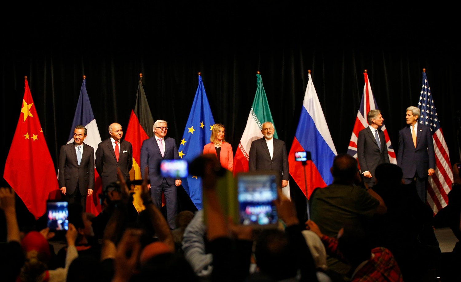 Chinese Foreign Minister Wang Yi, French Foreign Minister Laurent Fabius, German Foreign Minister Frank Walter Steinmeier, High Representative of the European Union for Foreign Affairs and Security Policy Federica Mogherini, Iranian Foreign Minister Mohammad Javad Zarif, British Foreign Secretary Philip Hammond and U.S. Secretary of State John Kerry (L-R) pose for a family picture after the last plenary session at the United Nations building in Vienna, Austria July 14, 2015. Iran and six major world powers reached a nuclear deal on Tuesday, capping more than a decade of on-off negotiations with an agreement that could potentially transform the Middle East, and which Israel called an "historic surrender". REUTERS/Leonhard Foeger - RTX1K9XC