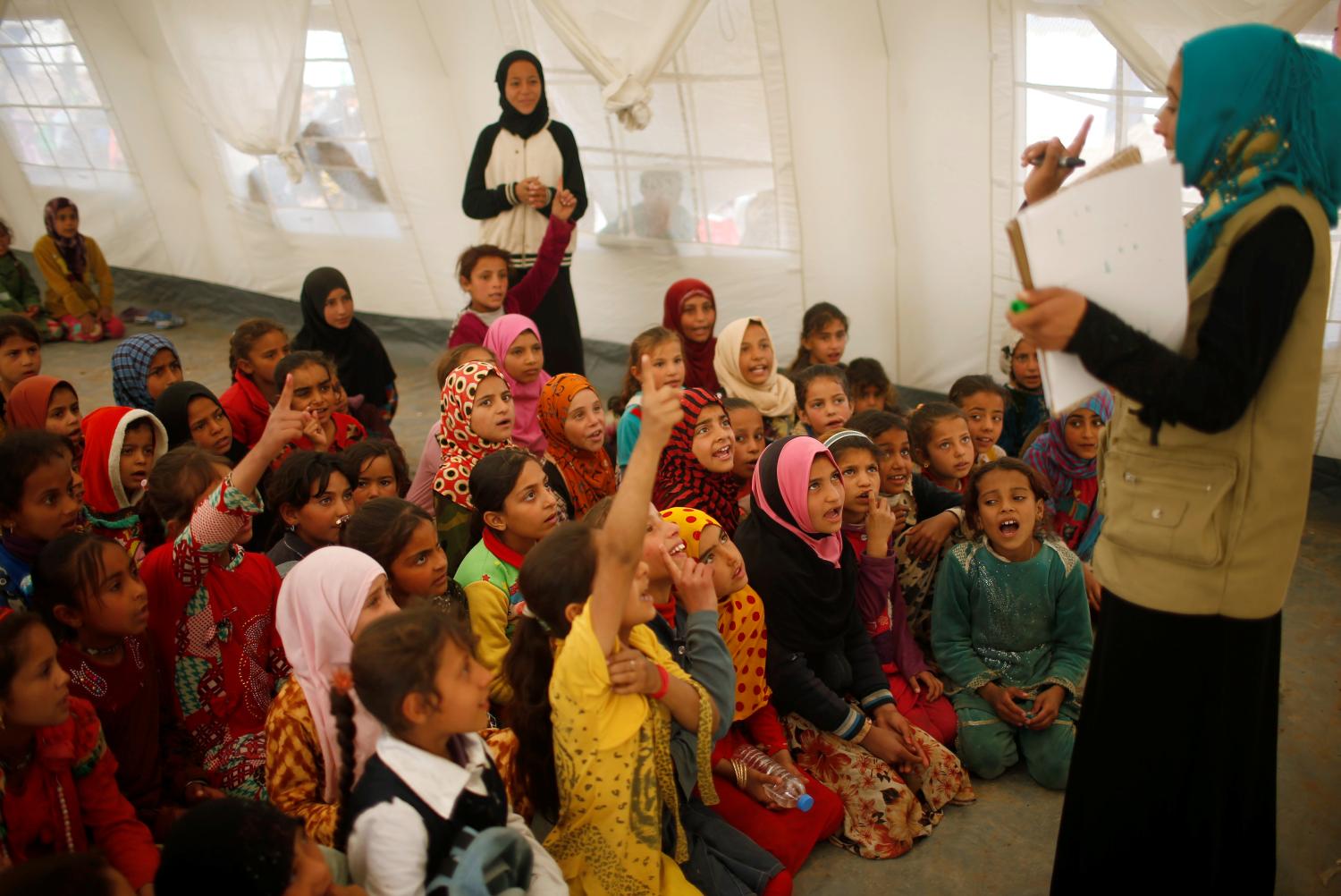 Displaced Iraqis who had fled their homes study inside a tent at Hammam al-Alil camp south of Mosul, Iraq March 29, 2017. Picture taken March 29, 2017. REUTERS/Suhaib Salem