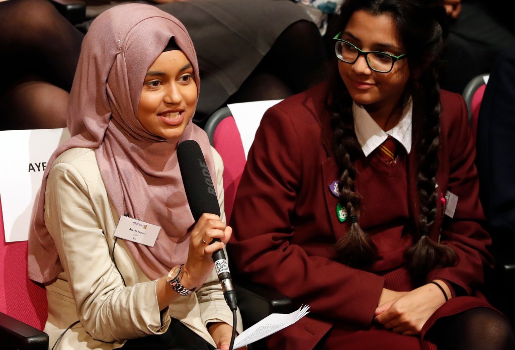 Ayesha Begum, 17 asks a question to the First Lady of the United States Michelle Obama, via a video link at the Mulberry School for Girls in London, Britain October 11, 2016. 'A Brighter Future: A Global Conversation on Girls? Education' was a digital conversation with adolescent girls around the world. The event took place in celebration of International Day of the Girl. Girls in Washington, D.C., Jordan, Peru, Tanzania, and the Mulberry School for Girls in the United Kingdom spoke with one another about the challenges they have faced and potentially overcome in attaining an education. REUTERS/Kirsty Wigglesworth/Pool - RTSRT6X