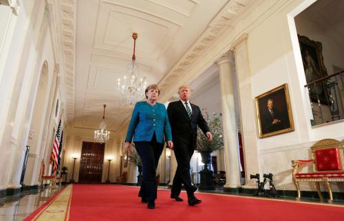 German Chancellor Angela Merkel (L) and U.S. President Donald Trump walk to a joint news conference in the East Room of the White House in Washington, U.S., March 17, 2017. REUTERS/Joshua Roberts