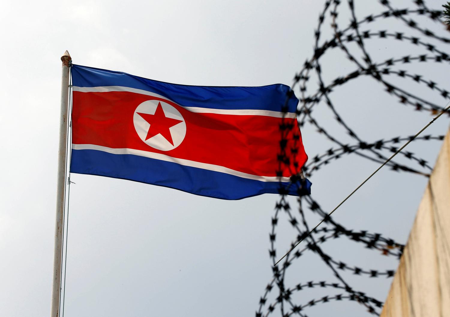 The North Korea flag flutters next to concertina wire at the North Korean embassy in Kuala Lumpur, Malaysia March 9, 2017. REUTERS/Edgar Su - RTS122QZ