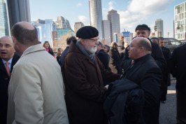 Older adult men talk in the Boston Seaport innovation district