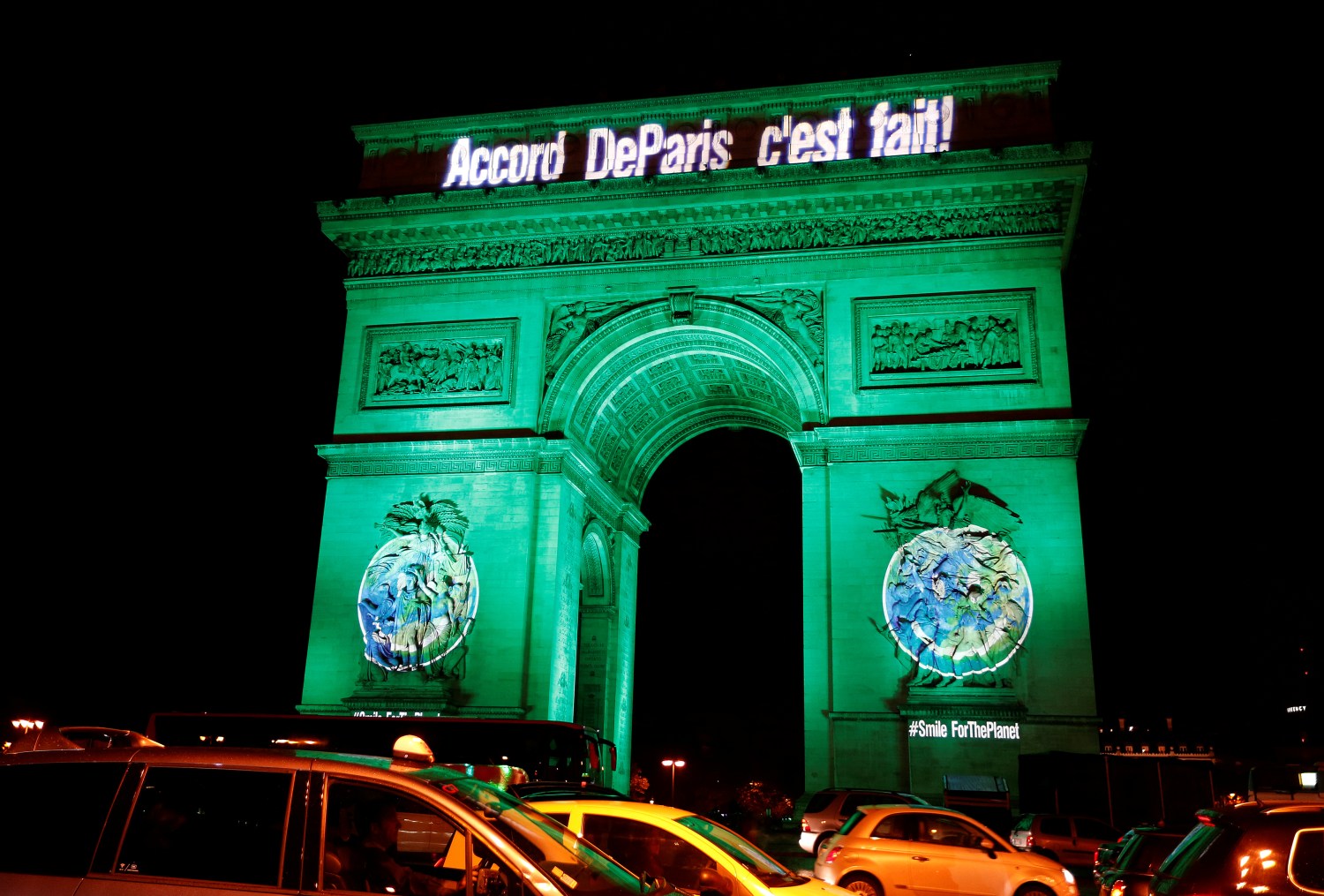 The Arc de Triomphe is illuminated in green with the words "Paris Agreement is Done", to celebrate the Paris U.N. COP21 Climate Change agreement in Paris