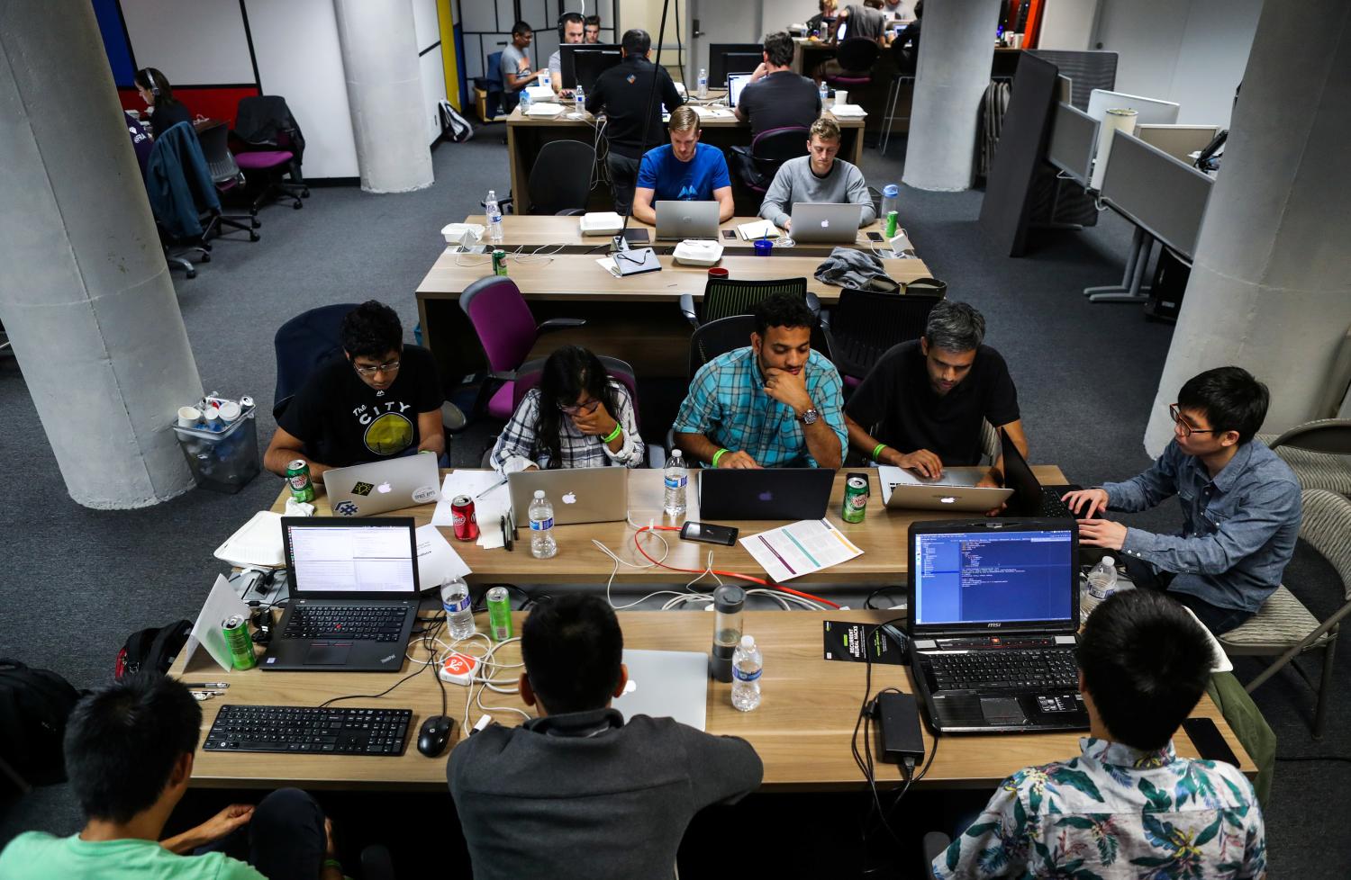 People work on their computers during a weekend Hackathon event.