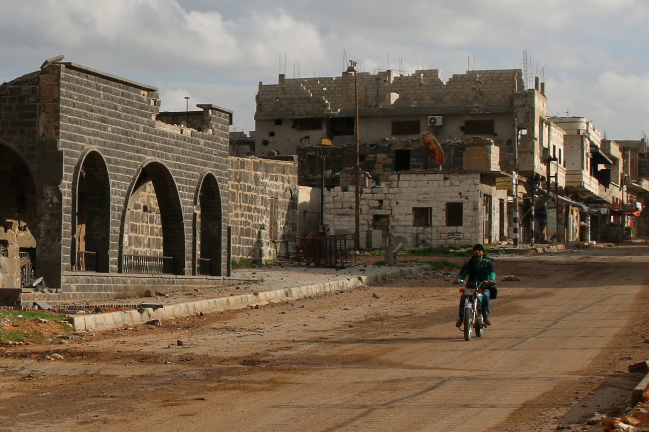 A man drives a motorcycle near damaged Omari Mosque in the southern old city of Deraa, Syria March 13, 2017. The Omari mosque is where the first protests started in Syria. Picture taken March 13, 2017. To match Analysis MIDEAST-CRISIS/SYRIA-WAR REUTERS/Alaa Al-Faqir - RTX311ZT