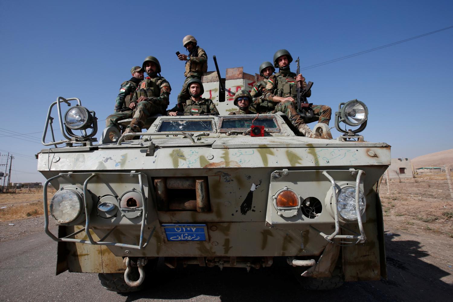 Syrian Kurdish fighters ride a military vehicle in the town of Bashiqa, after it was recaptured from the Islamic State, east of Mosul, Iraq, November 12, 2016. Picture taken November 12, 2016. REUTERS/Azad Lashkari - RTX2TLWS