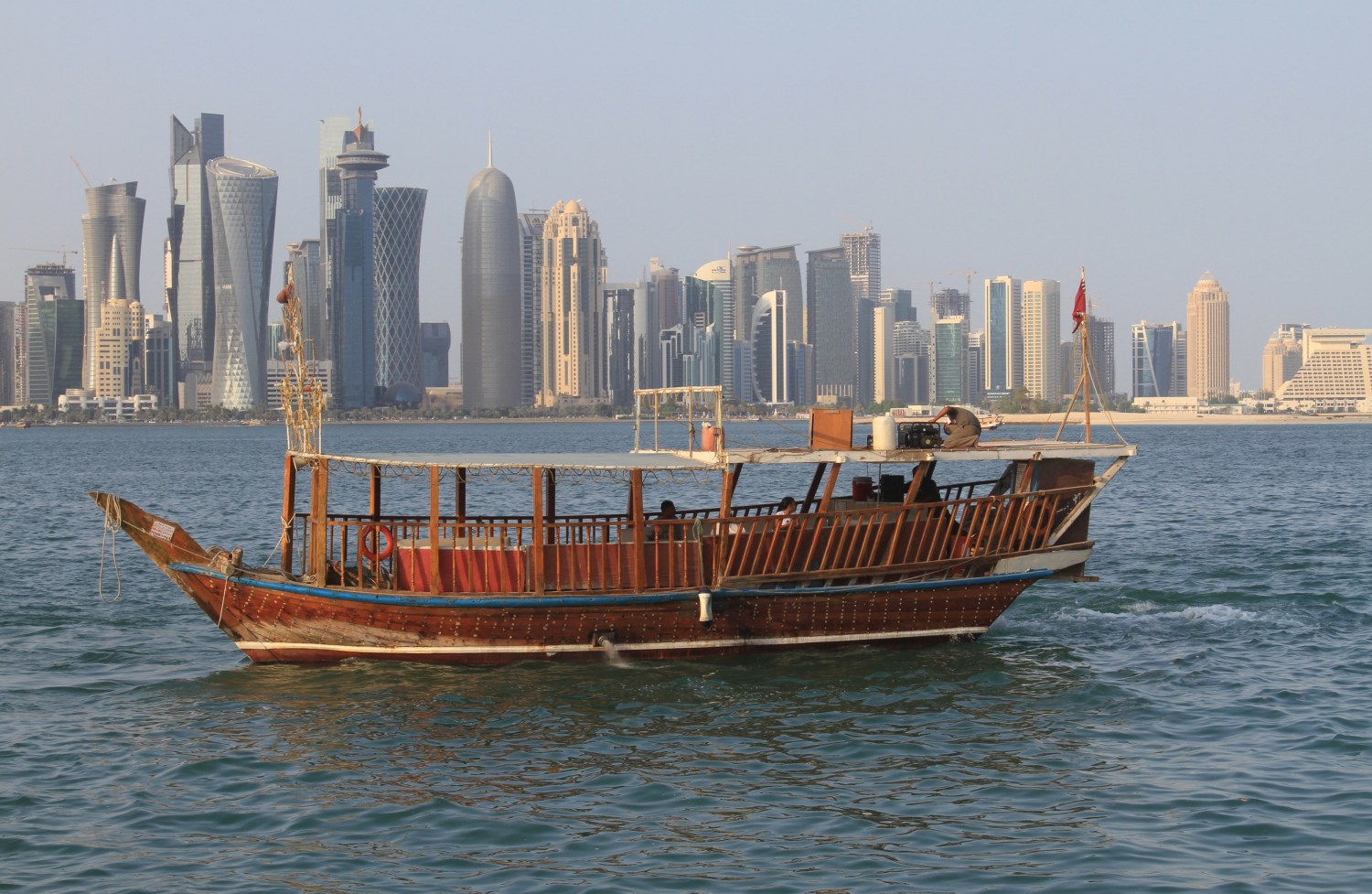 People travel in a traditional boat at Doha Corniche, Qatar