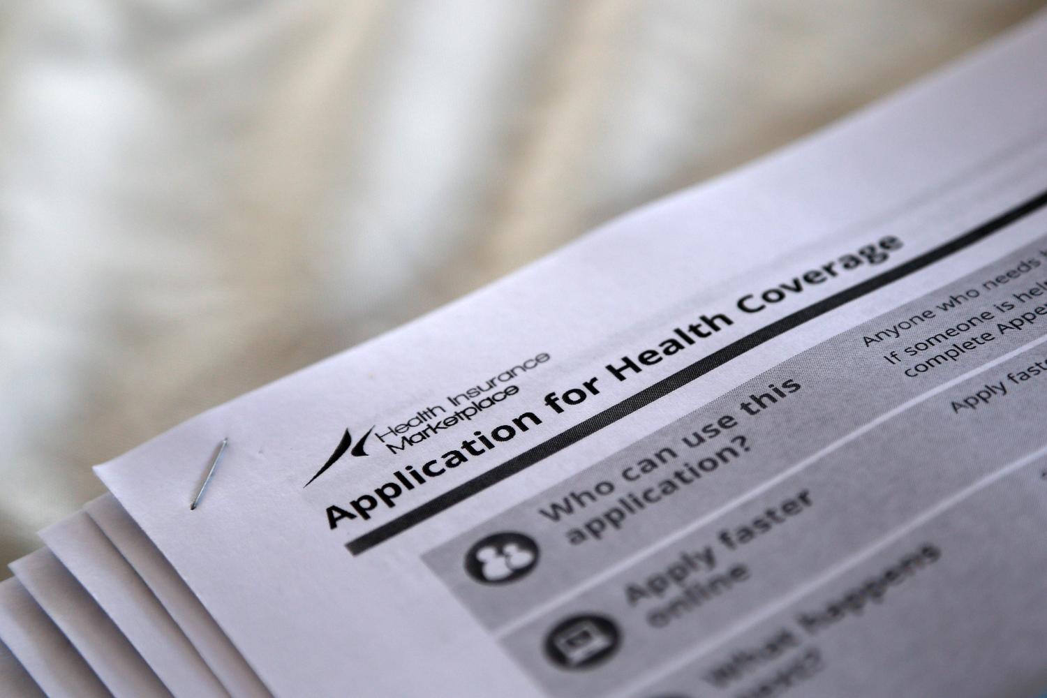 Applications are seen at a rally held by supporters of the Affordable Care Act in Jackson, Mississippi