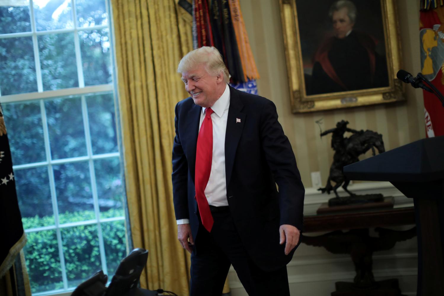 U.S. President Donald Trump reacts during a schedule signing ceremony of executive orders on trade at the Oval Office of the White House in Washington