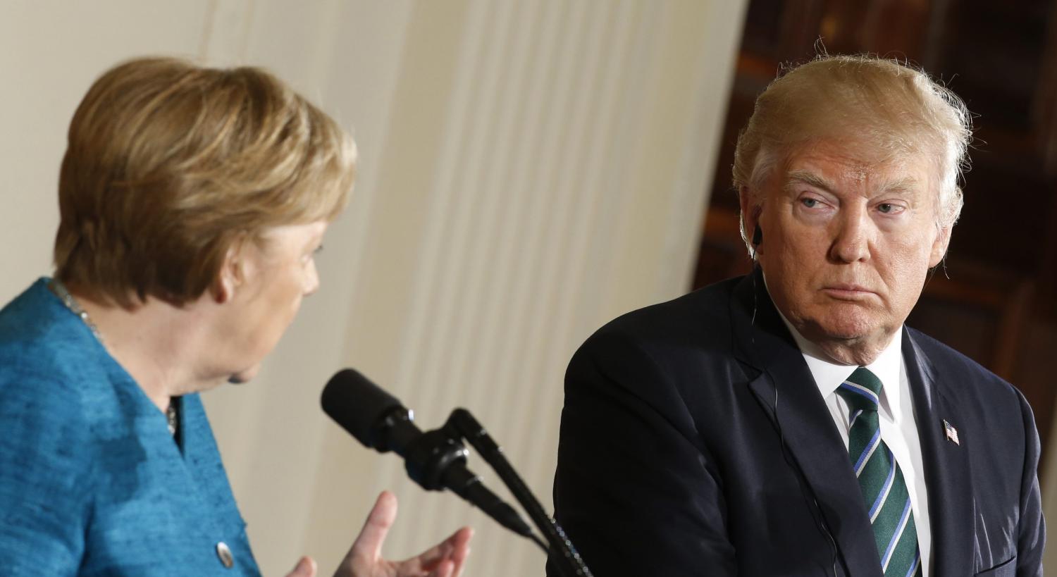 Germany's Chancellor Angela Merkel speaks as U.S. President Donald Trump looks on during their joint news conference in the East Room of the White House in Washington, U.S., March 17, 2017. REUTERS/Joshua Roberts