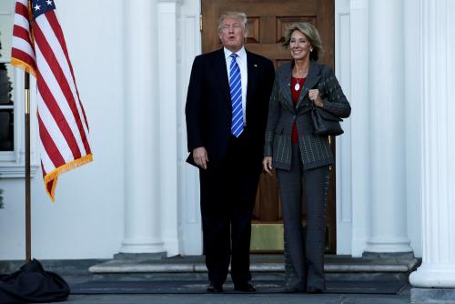 U.S. President-elect Donald Trump (L) stands with Betsy DeVos after their meeting at the main clubhouse at Trump National Golf Club in Bedminster, New Jersey, U.S., November 19, 2016. REUTERS/Mike Segar - RTSSFF5