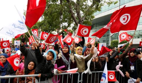 People wave national flags during celebrations marking the sixth anniversary of Tunisia's 2011 revolution in Habib Bourguiba Avenue in Tunis, Tunisia January 14, 2017. REUTERS/Zoubeir Souissi - RTSVIMM