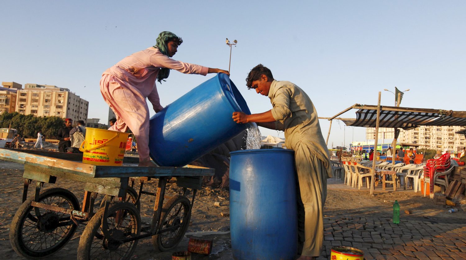 Men pour water brought by cart into a container at a stall on Clifton Beach in Karachi, Pakistan March 5, 2016. Some 650 million people, or one in 10 of the world's population, have no access to safe water, putting them at risk of infectious diseases and premature death. Dirty water and poor sanitation can cause severe diarrhoeal diseases in children, killing 900 under-five a day across the world, according to United Nations estimates. World Water Day, marked this year on March 22, highlights various concerns about the world's water resources, and in 2016 is focusing on how good access to safe water can create paid work and contribute to a greener economy. REUTERS/Akhtar Soomro SEARCH "SAFE WATER" FOR THIS STORY. SEARCH "THE WIDER IMAGE" FOR ALL STORIES - RTSANXL