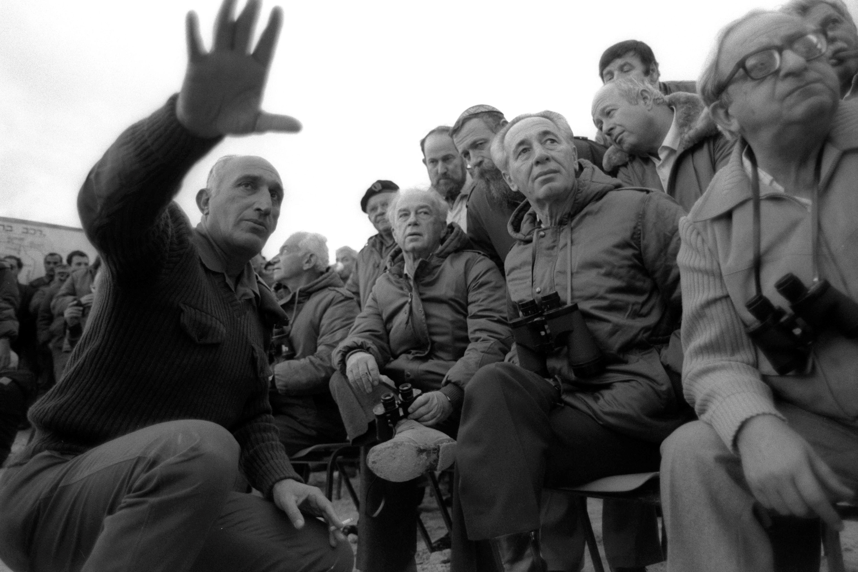 Israel's Deputy Prime Minister Yitzhak Navon, Prime Minister Shimon Peres (2nd R), Defence Minister Yitzhak Rabin (3rd R) are briefed by army Chief of Staff Moshe Levy (L) during a large scale military maneuver in Israel in this December 4, 1985 file photo released by the Israeli Government Press Office (GPO). REUTERS/Nati Harnik/GPO/Handout FOR EDITORIAL USE ONLY. NOT FOR SALE FOR MARKETING OR ADVERTISING CAMPAIGNS. ISRAEL OUT. NO COMMERCIAL OR EDITORIAL SALES IN ISRAEL. BLACK AND WHITE ONLY TPX IMAGES OF THE DAY - RTSPRLG
