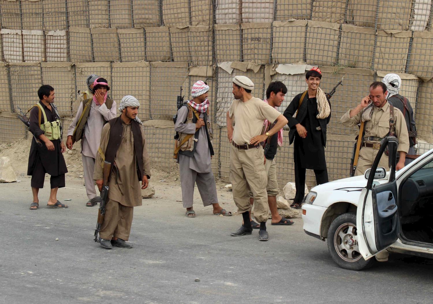 Afghan local police (ALP) keep watch at a checkpoint at Chardara district, in Kunduz province, Afghanistan June 23, 2015. Afghan government forces regained control of a key district near the northern city of Kunduz on Tuesday, after Taliban fighters had threatened to capture a provincial capital for the first time since being driven from power in 2001. REUTERS/Stringer - RTX1HQEK