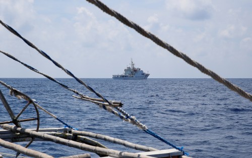 A China Coast Guard ship is seen from a Philippine fishing boat at the disputed Scarborough Shoal April 6, 2017. Picture taken April 6, 2017. REUTERS/Erik De Castro - RTX34VG6