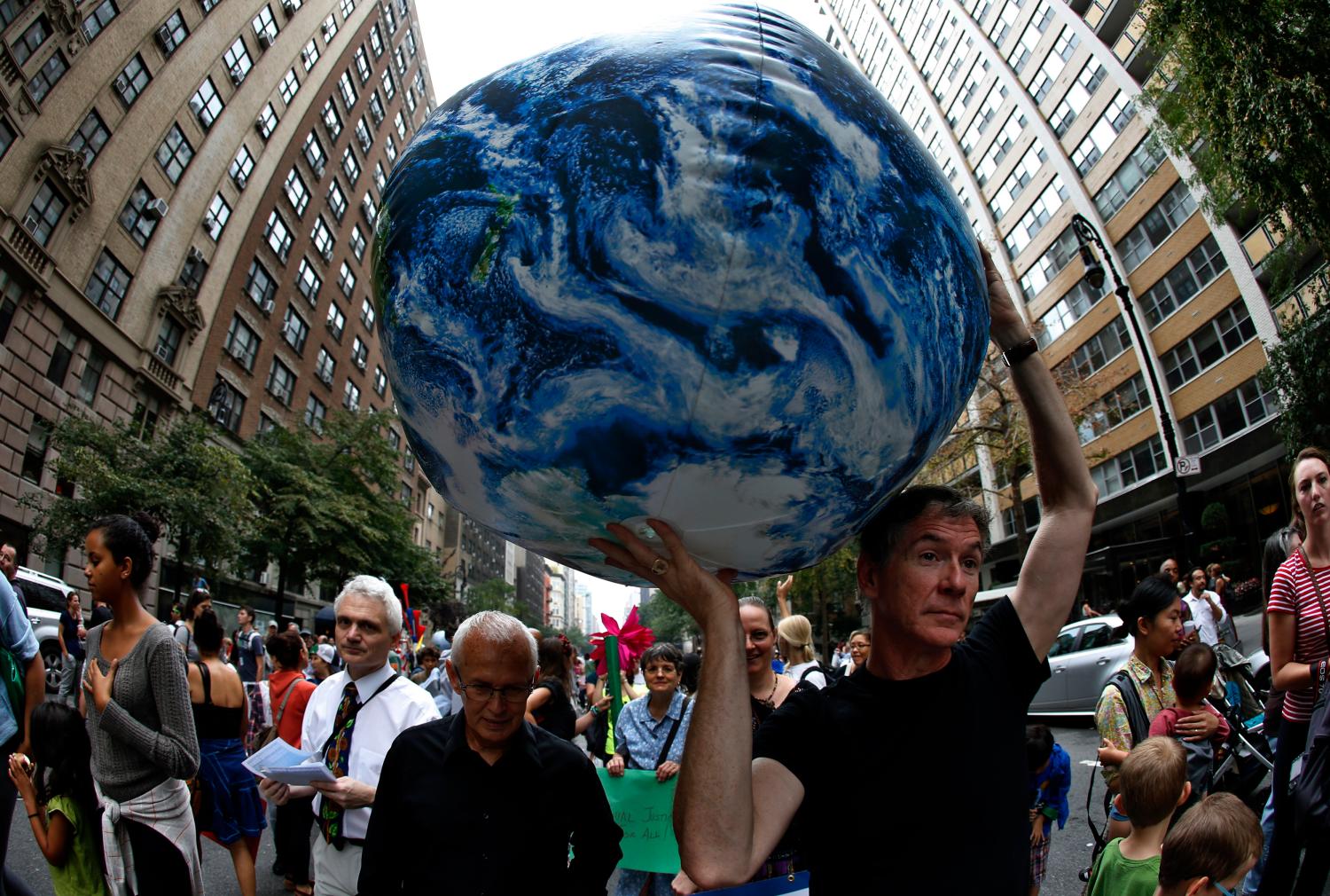 A man carries an inflatable earth balloon along West 72nd Street during the People's Climate March in New York