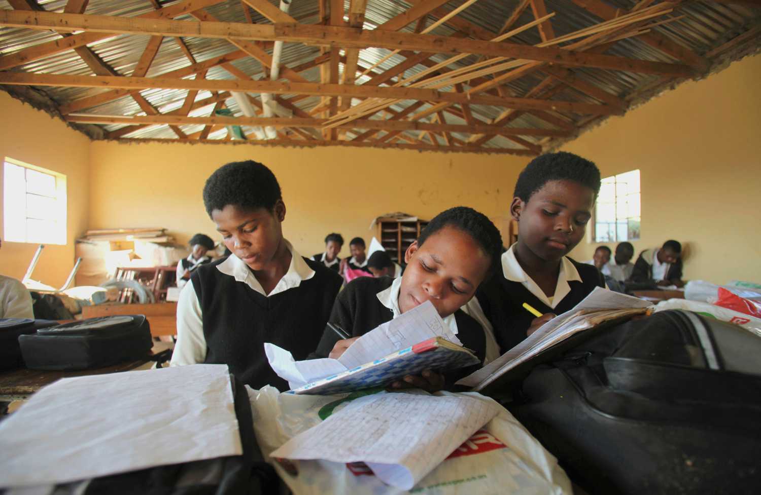 Children write notes from a makeshift black board at a school in Mwezeni village in South Africa's Eastern Cape Province
