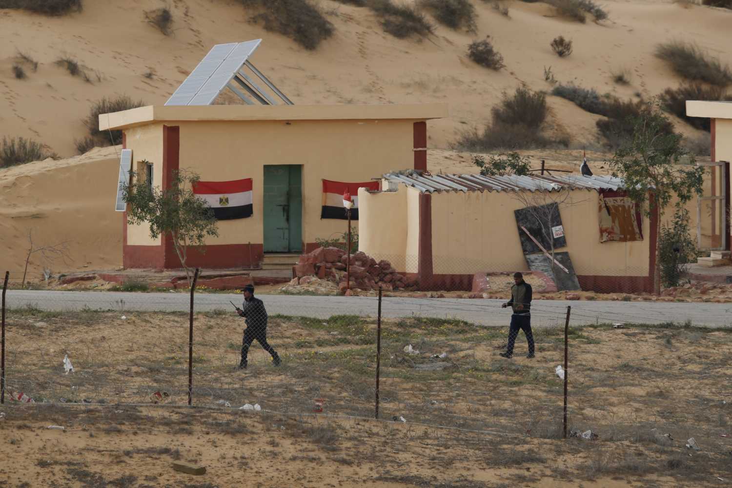 Egyptian policemen walk next to a border post, as seen from the Israeli side of the border with Egypt's Sinai peninsula, in Israel's Negev Desert February 10, 2016. REUTERS/Amir Cohen
