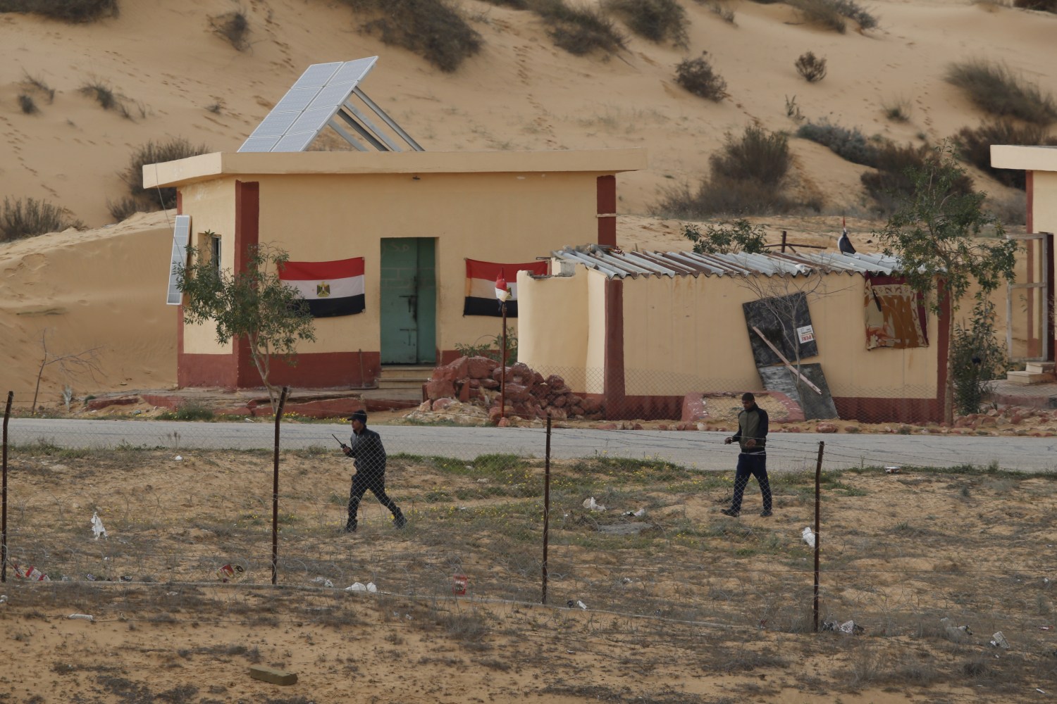 Egyptian policemen walk next to a border post, as seen from the Israeli side of the border with Egypt's Sinai peninsula, in Israel's Negev Desert February 10, 2016. REUTERS/Amir Cohen