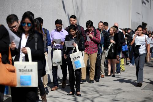 : People wait in line to attend TechFair LA, a technology job fair, in Los Angeles, California.