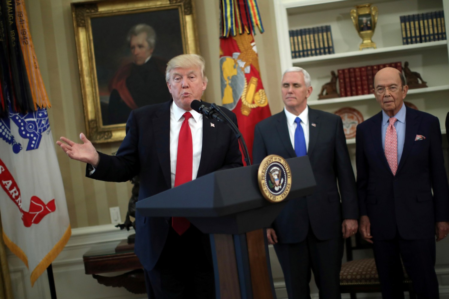 U.S. President Donald Trump speaks during a signing ceremony of executive orders on trade, accompanied by Vice President Mike Pence (C) and U.S. Commerce Secretary Wilbur Ross (R) at the Oval Office of the White House in Washington, U.S., March 31, 2017. REUTERS/Carlos Barria - RTX33KXG