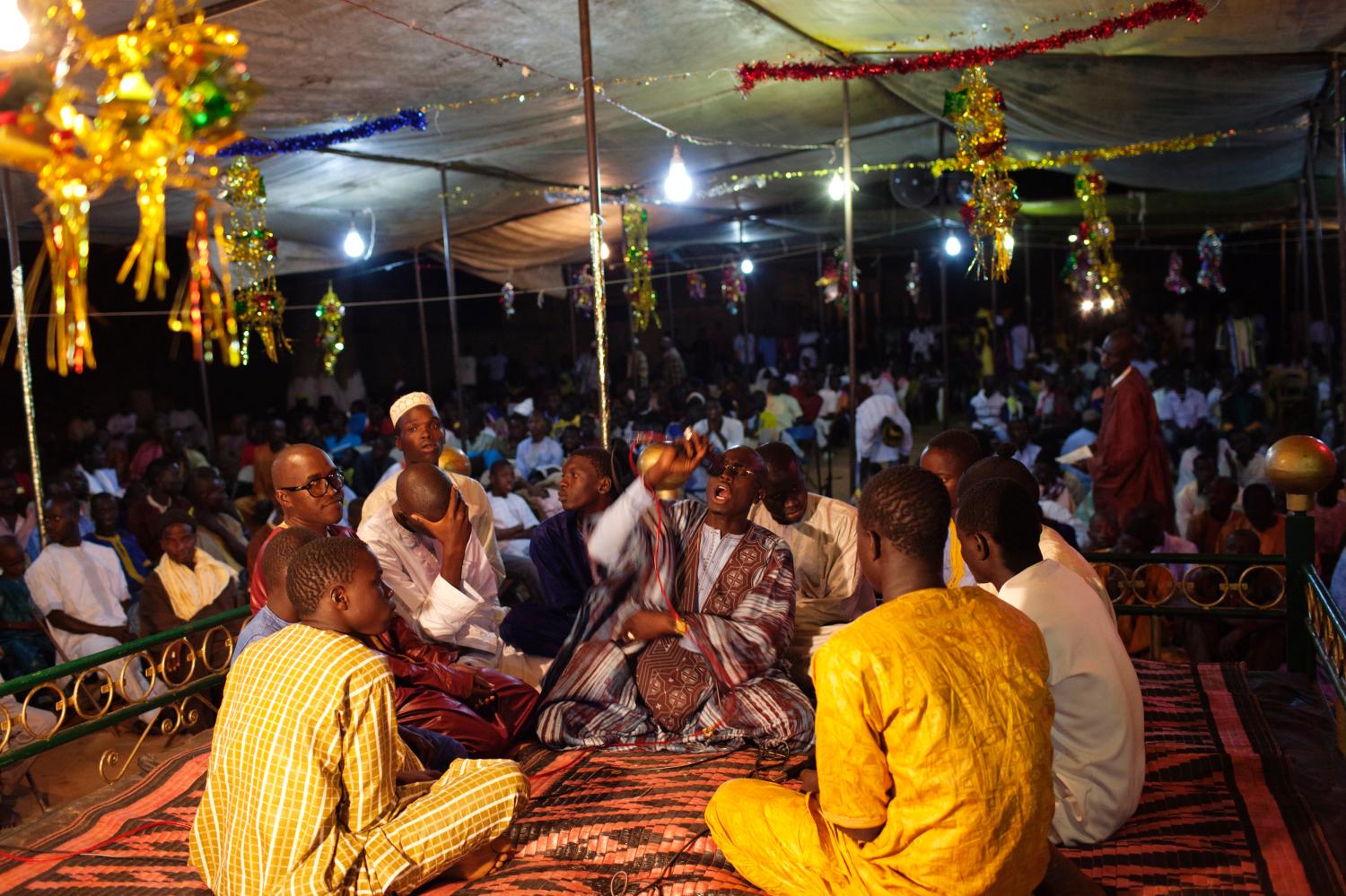 People from the Mouride sect of Sufi Islam chant prayers in the village of Ndande, May 18, 2013. Every year, inhabitants of the village take part in a Sufi Muslim ceremony called Gamou-Ndande. The ceremony combines nights of praying and chanting as well as traditionally animist ceremonies. Picture taken May 18, 2013. REUTERS/Joe Penney (SENEGAL - Tags: RELIGION SOCIETY) - RTXZWN5