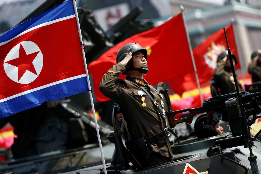 A soldier salutes from atop an armoured vehicle as it drives past the stand with North Korean leader Kim Jong Un during a military parade marking the 105th birth anniversary of country's founding father Kim Il Sung, in Pyongyang April 15, 2017. REUTERS/Damir Sagolj - RTS12E3O