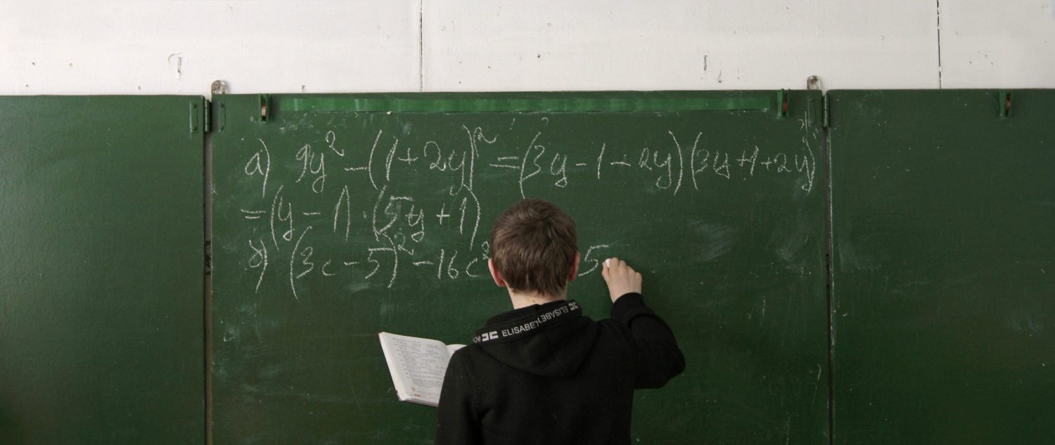 Andrey Marchenkov, 13 writes on the blackboard as he attends a mathematics lesson at a local school based in the remote Russian village of Bolshie Khutora