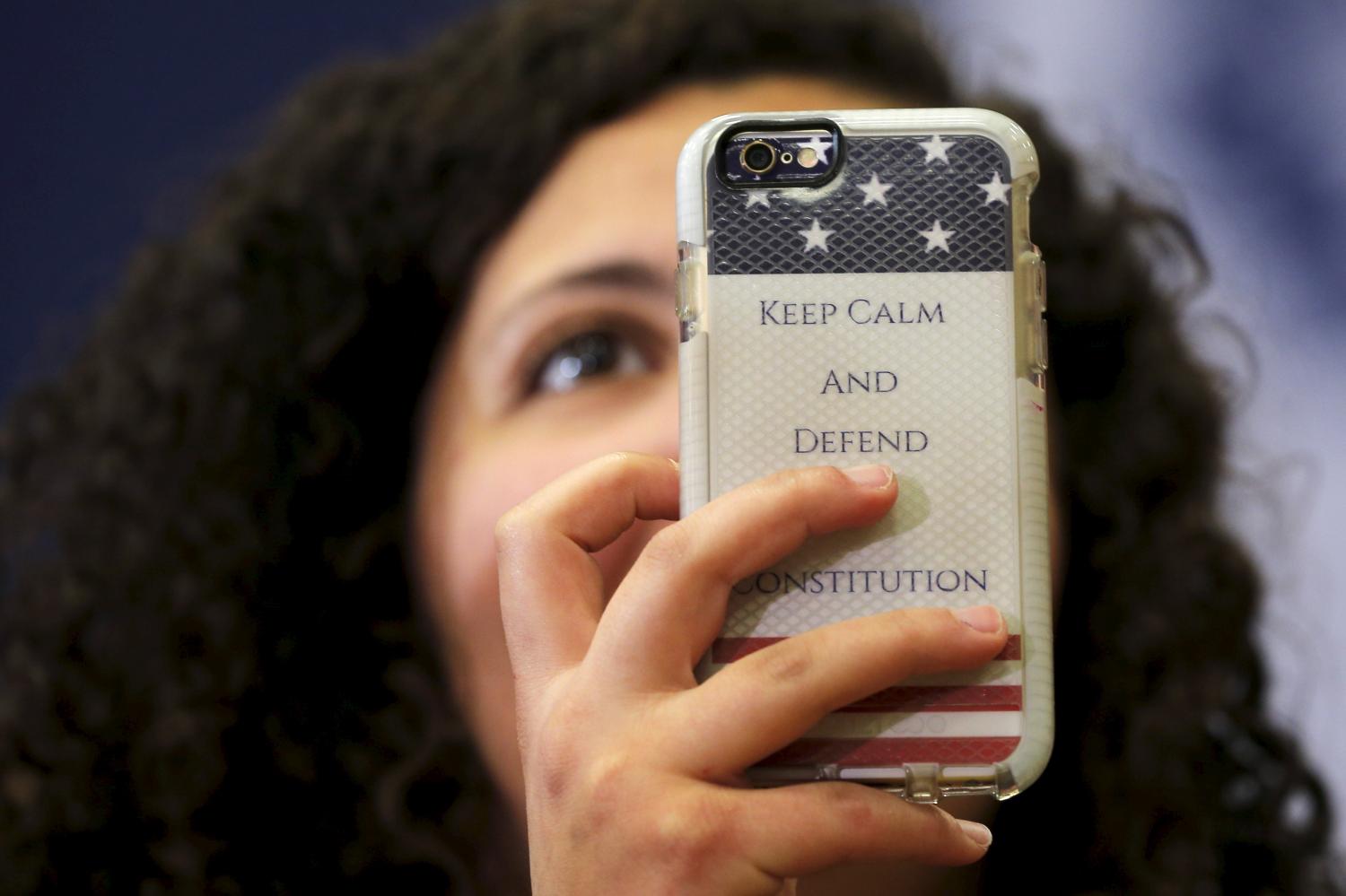 An audience member holds up a phone with a case reading "Keep Calm and Defend the Constitution" during a "Get Out to Caucus" rally with U.S. Democratic presidential candidate Hillary Clinton in Cedar Rapids, Iowa
