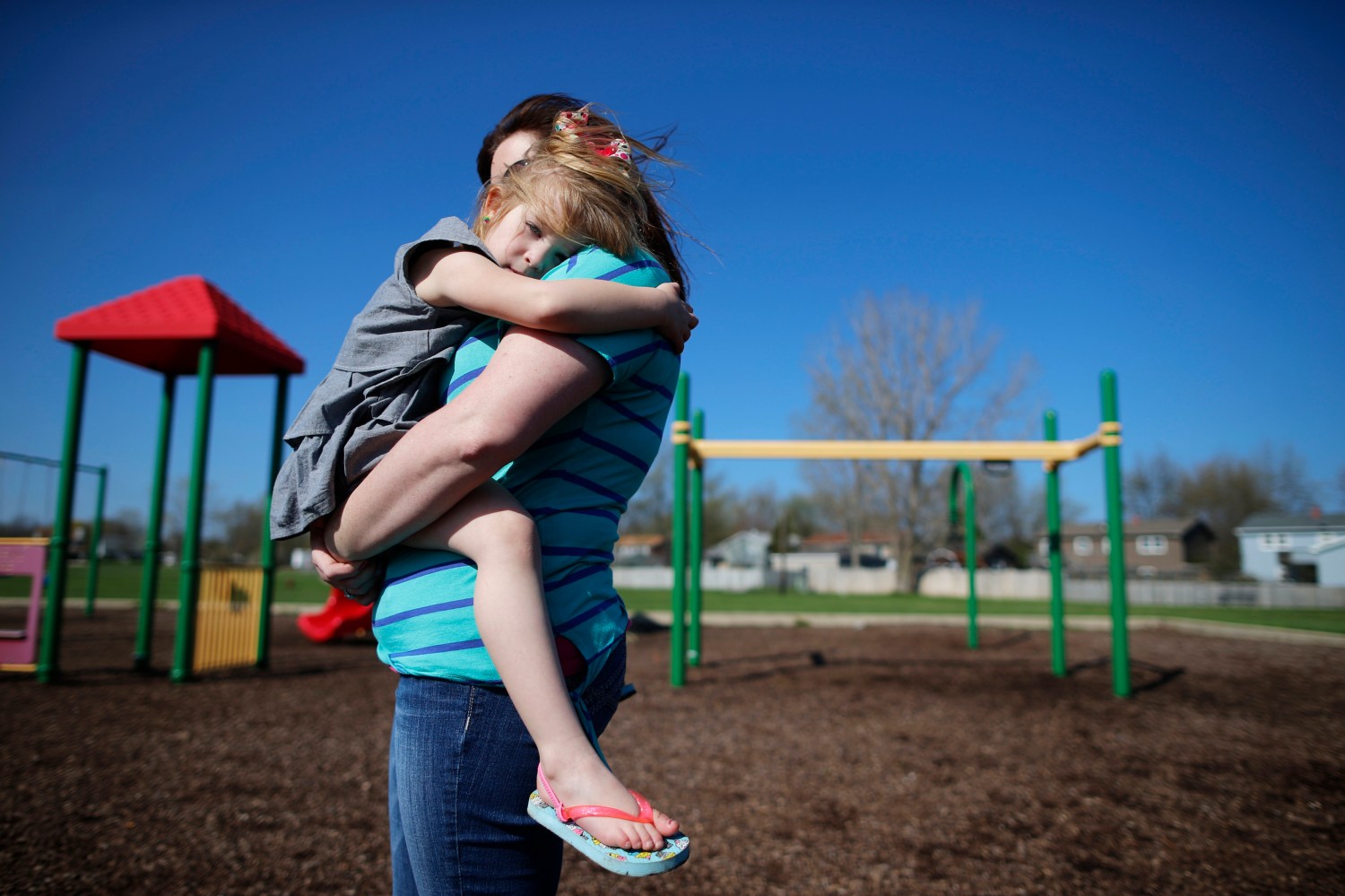 Andrea Smith holds her daughter Norah at a playground in Winthrop Harbor, Illinois