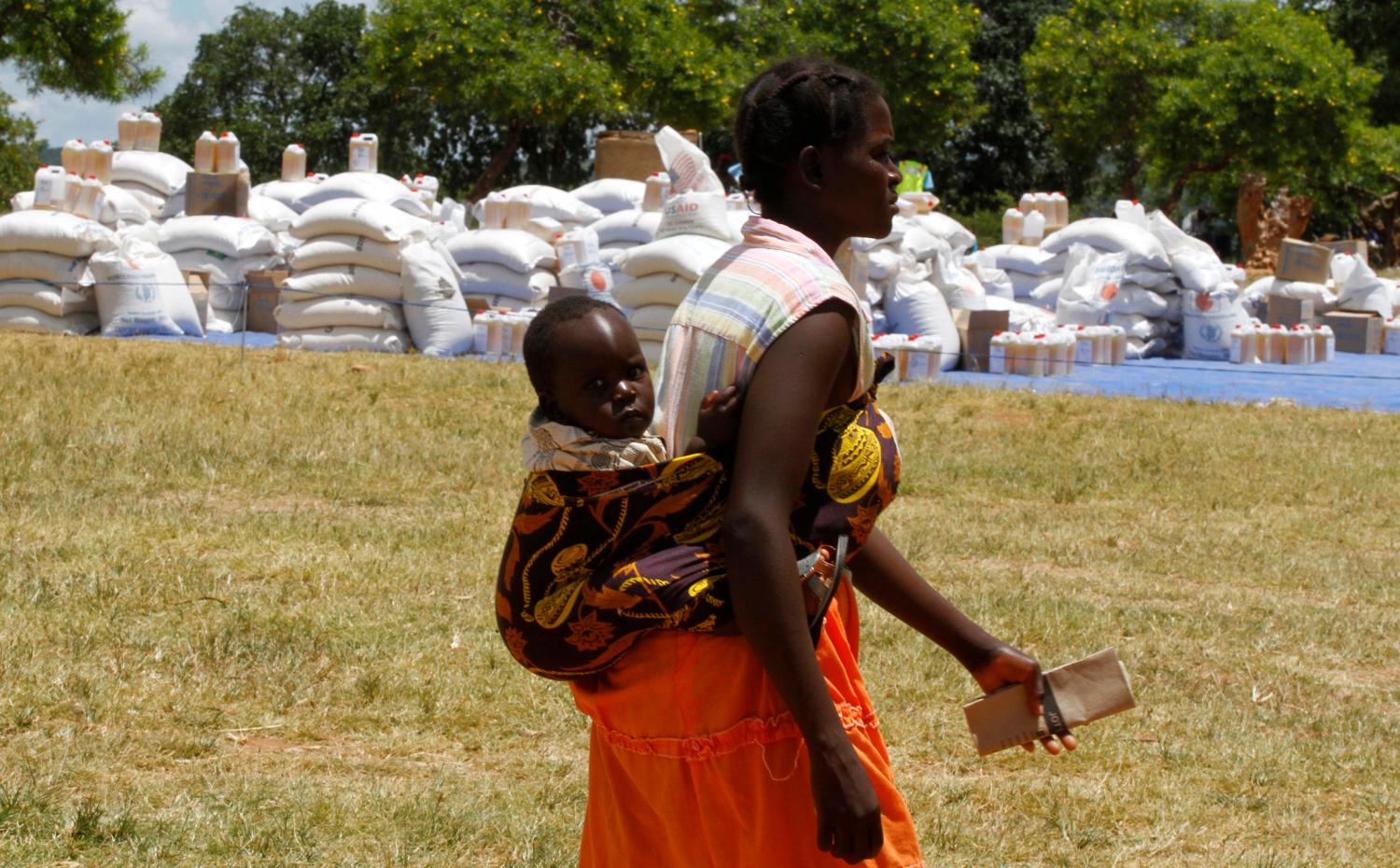 A Zimbabwean mother arrives to collect her monthly rations of food aid from Rutaura Primary School in Rushinga district of Mt Darwin about 254km north of Harare