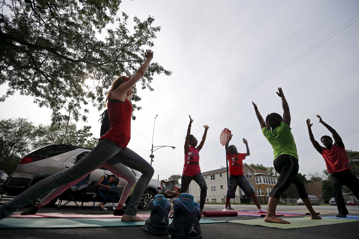 Mothers Against Senseless Killings founder Tamar Manasseh takes part in a yoga class on a street intersection in the Englewood neighborhood of Chicago
