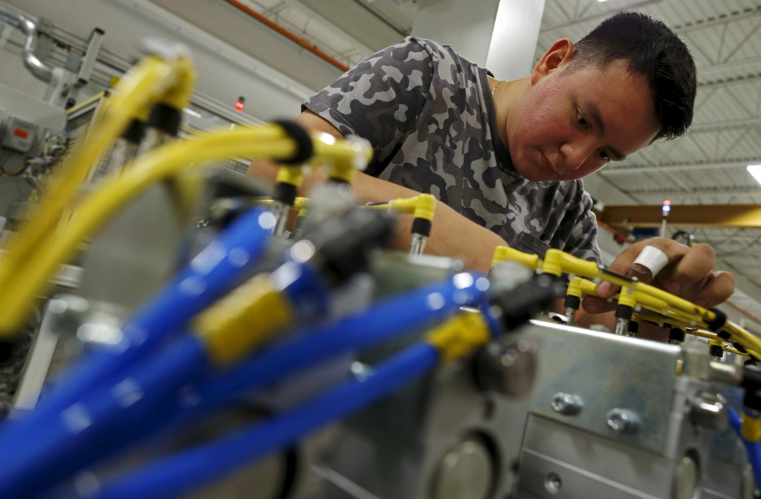 Christian Reyes works on some wiring at Felsomat in the Chicago suburb of Schaumburg