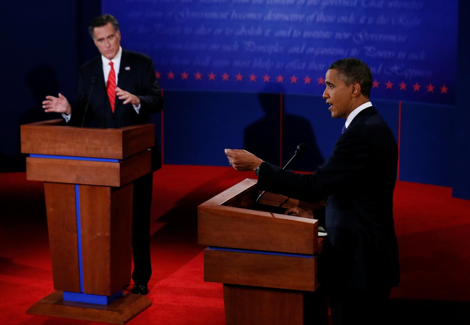 President Barack Obama answers a question as Republican presidential nominee Mitt Romney listens during the first 2012 U.S. presidential debate in Denver