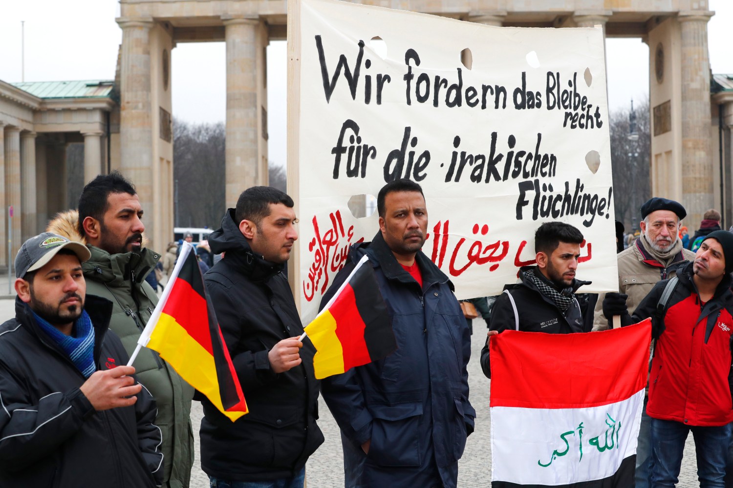 People protest against the deportation of Iraqi refugees from Germany at the Brandenburg Gate in Berlin
