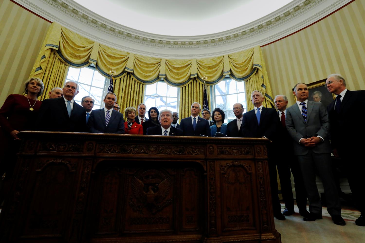 Trump signs an executive order in the Oval Office at the White House in Washington