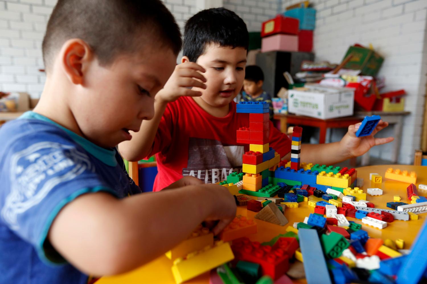 Preschool students play on their first day at a public school in the shanty town of Ticlio Chico