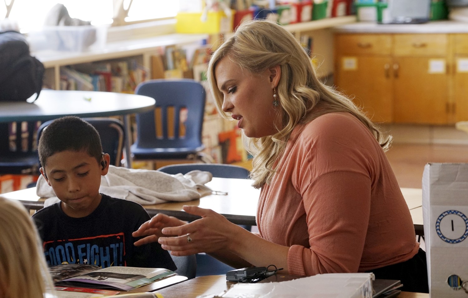 Kyle Schwartz, 3rd grade teacher, works with a student at Doull Elementary School in Denver