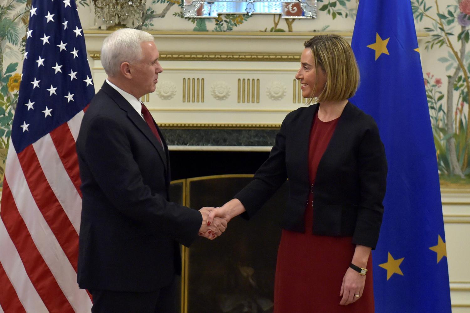U.S. Vice President Pence shakes hands with EU foreign policy chief Mogherini in Brussels