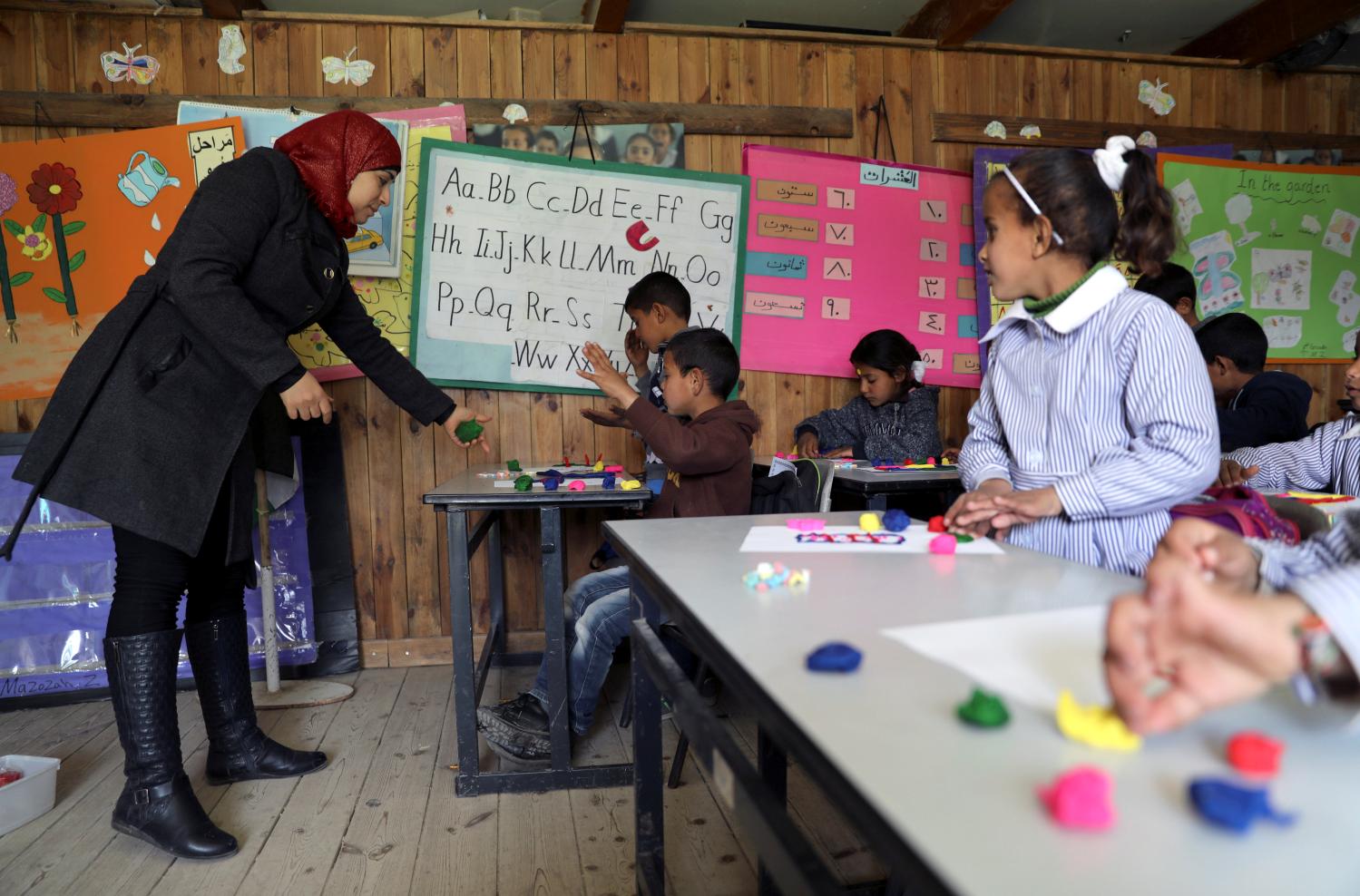 Bedouin Palestinian schoolchildren attend a lesson inside a classroom at their school in al-Khan al-Ahmar village near the West Bank city of Jericho