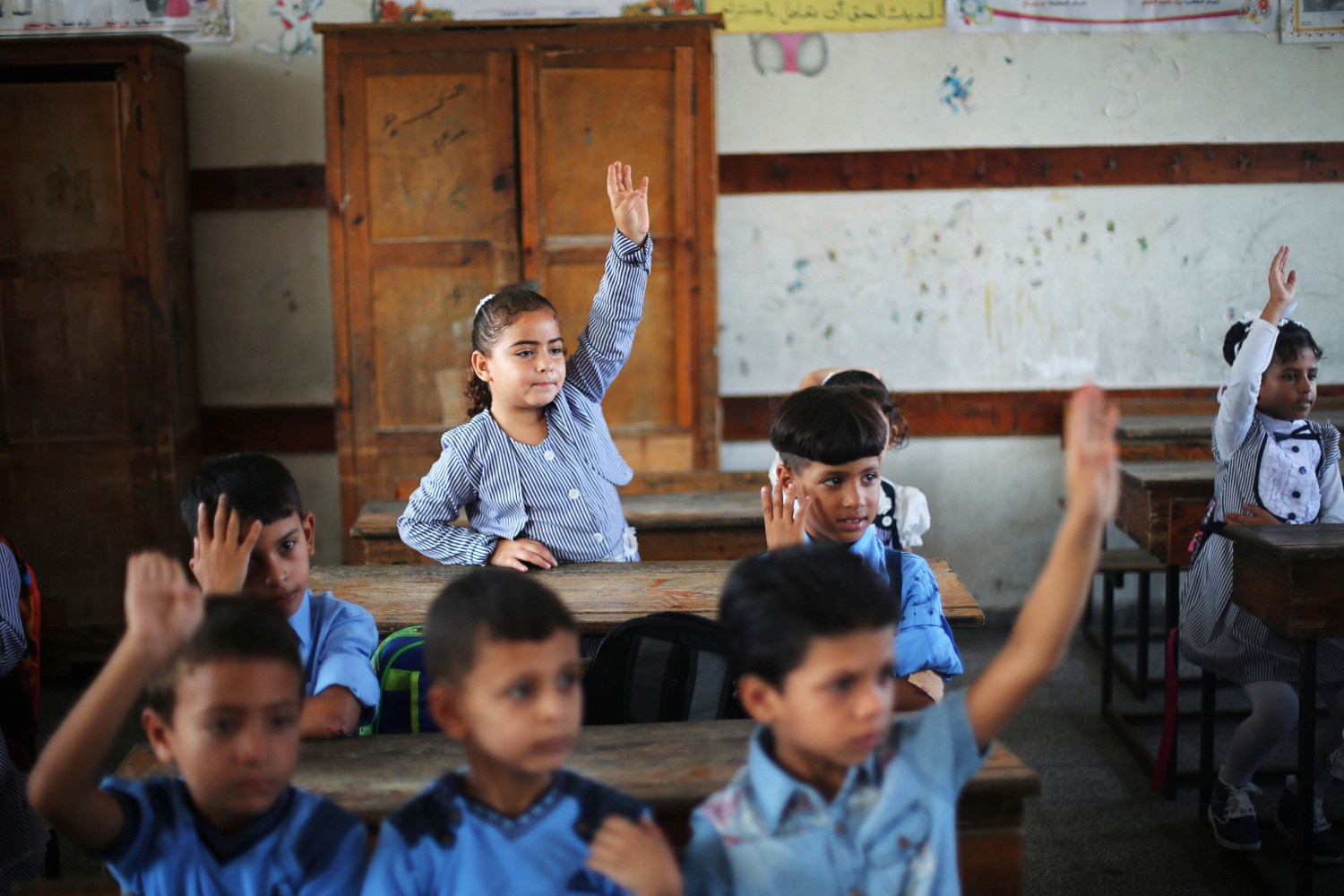 Palestinian schoolchildren attend a lesson in a classroom on the first day of a new school year, at a United Nations-run school in Khan Young in the southern Gaza Strip