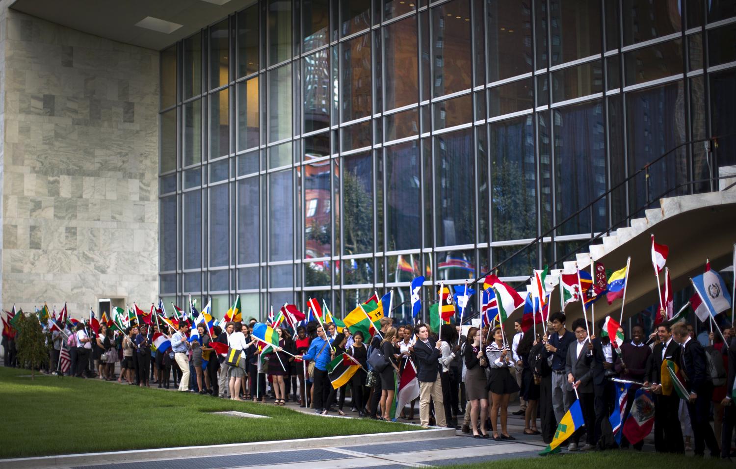 School children hold flags as they take part in the annual peace bell ceremony to commemorate the International Day of Peace at U.N. headquarters in New York