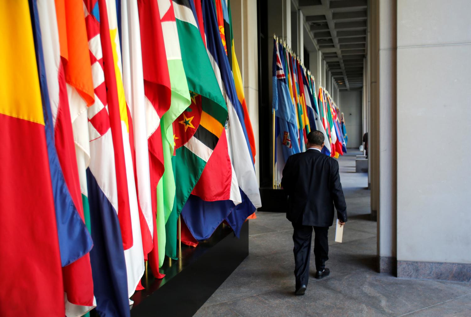 A delegate walks outside International Monetary Fund headquarters