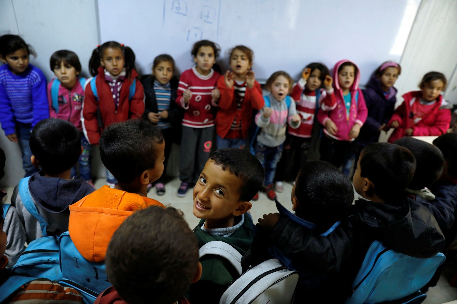 Syrian refugee students sing a song during a lesson at a school in Nizip refugee camp